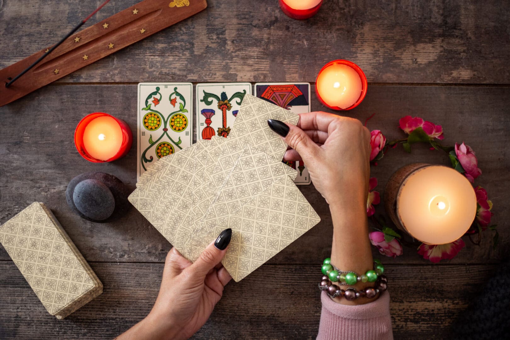Fortune teller reading a future by tarot cards on rustic table